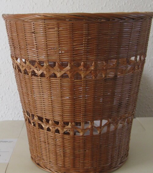 Brown wickerwork waste paper basket