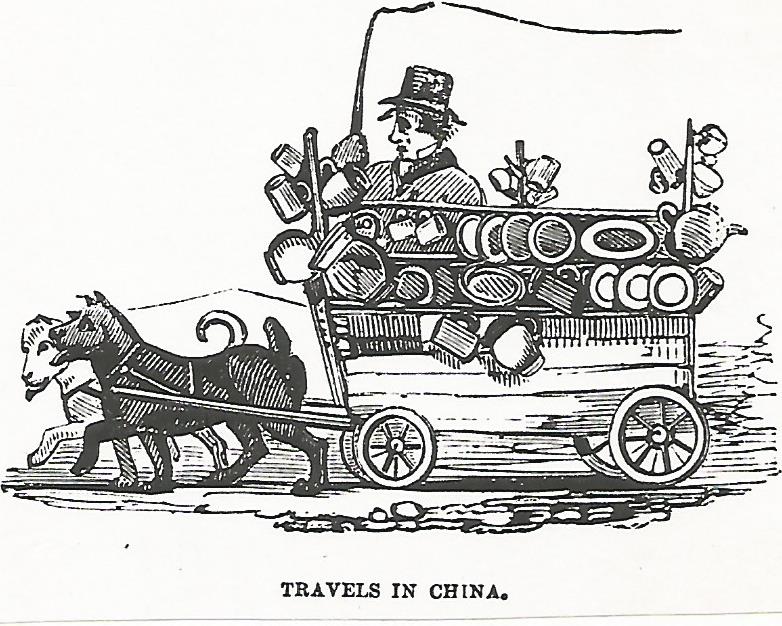 Two dogs walking left pullingart loaded with pots and plates