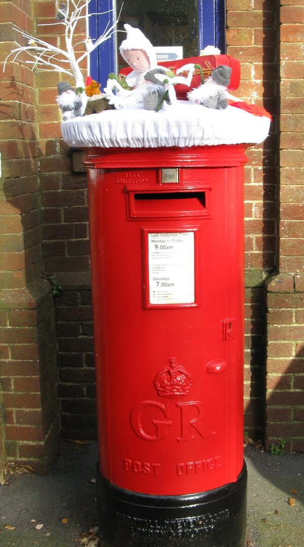 Red pillar box decorated wih knitted objectsth