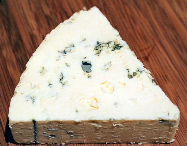 Danish Blue. Image by R.N Marshman CC BY-SA 3.0 via Wikimedia Commons Triangular slice of Danish Blue cheese point right