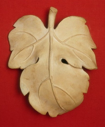 White plaster figleaf on red background