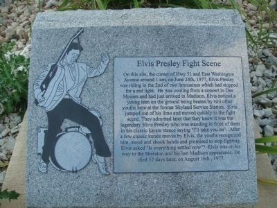 Elvis Presley figure wth guitar on left of text on stone plaque    e