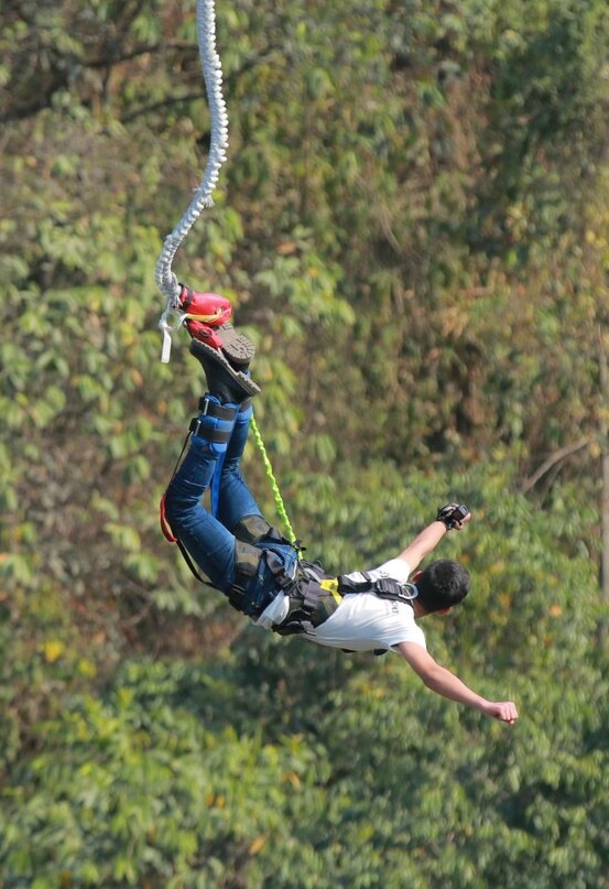 Man (head down) bungee jumping